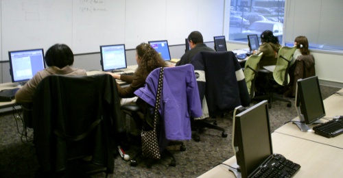 Image of disabled employees working or training at accessible workstations.